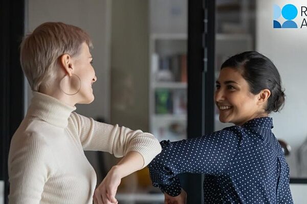 Two people bumping elbows in greeting